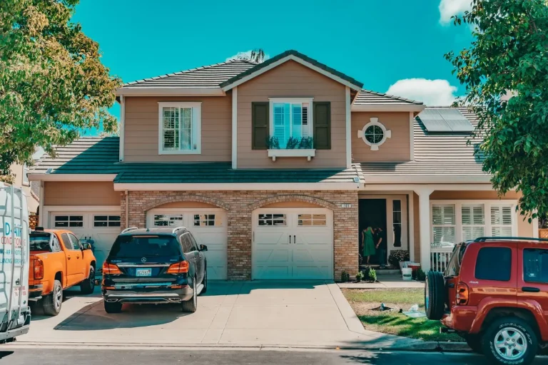 Carriage-style garage doors with windows on a brick-front home