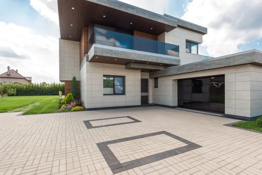Modern home with an attached garage and paver driveway