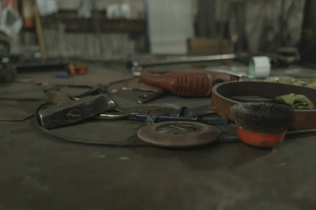 Workbench with tools and parts in a dim workshop