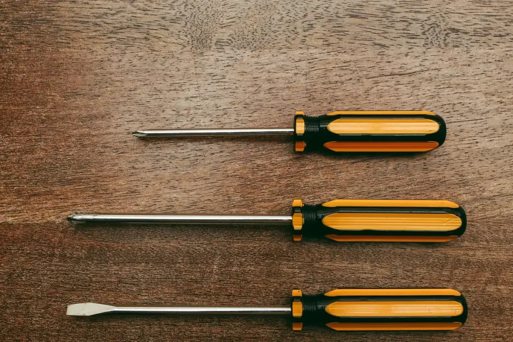 Screwdrivers laid out for mounting a new garage door opener